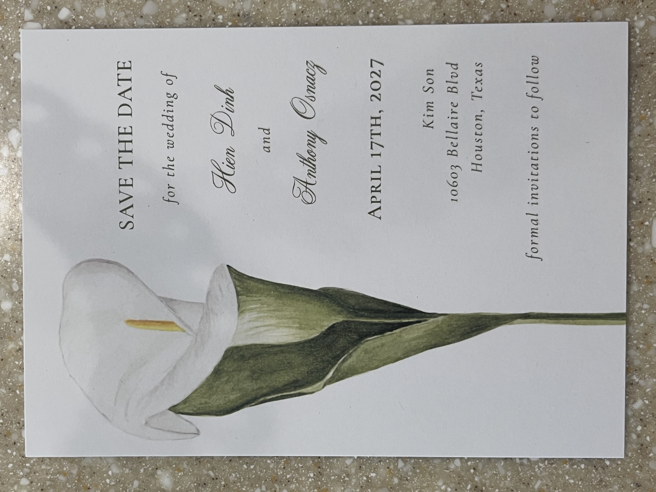 Anthony and Hien's handmade save-the-date featuring a painted white calla lily